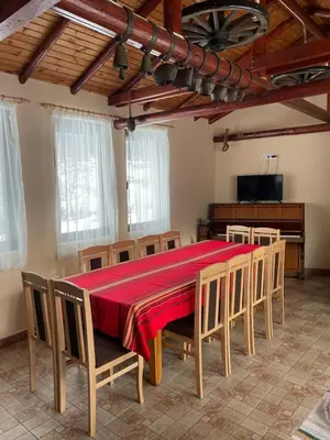 a dining room with a red table and chairs at Mama Emiliya Guest House in Beli Iskar