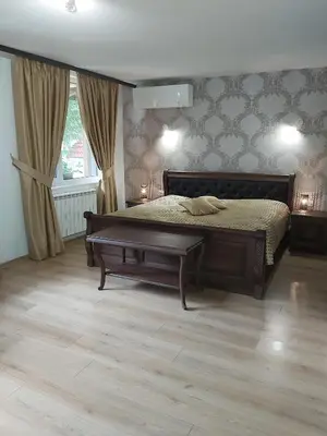 a bedroom with a bed and a coffee table at Galaxy Hotel in Chiflik
