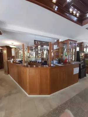 a bar in a restaurant with wooden cabinets at Galaxy Hotel in Chiflik