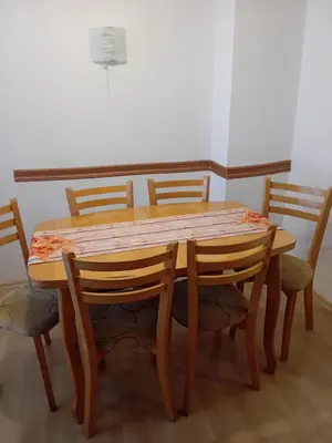 a wooden table with four chairs around it at Apartment Lili in Blagoevgrad