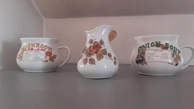 three vases and two cups sitting on a table at Central Park Studio in Plovdiv