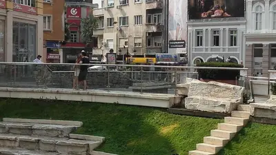 a couple of people standing on a ledge in a city at Central Park Studio in Plovdiv