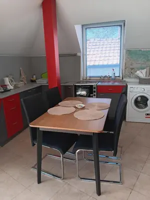 a kitchen with a wooden table and black chairs at Central Park Studio in Plovdiv