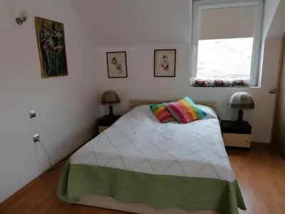 a bedroom with a bed and a window at Central Park Studio in Plovdiv