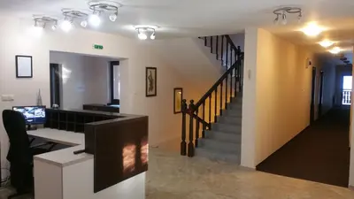a living room with a staircase and a stair case at Hunting Residence Lodge in Panichishte