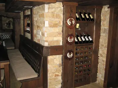 a room with a wall of wine bottles at Hunting Residence Lodge in Panichishte