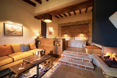 a living room with a couch and a fireplace at Zornitza Family Estate Relais & Chateaux in Melnik