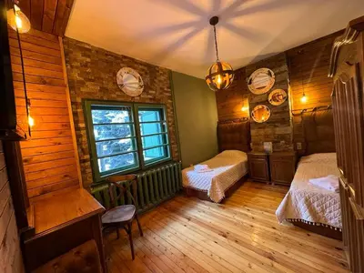 a bedroom with two beds and a window at Villa Adis with Hot Pool & Jacuzzi by BookVillaBG in Borovets