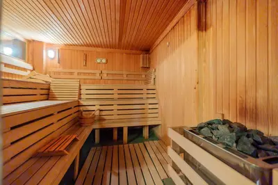 an empty sauna with wooden walls and wooden floors at Villa Adis with Hot Pool & Jacuzzi by BookVillaBG in Borovets