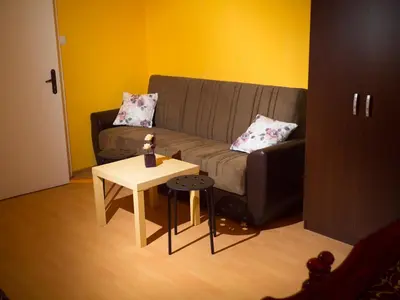 a living room with a couch and a table at Serdika Rooms in Sofia