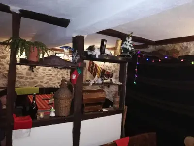 a room with wooden shelves and christmas lights at Eco Village Under the Cliffs in Ilindentsi