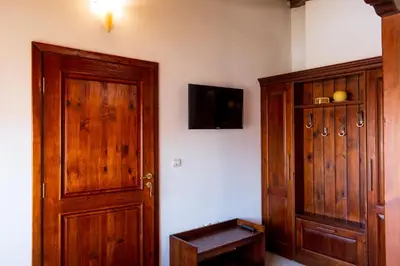 a room with a wooden door and a tv at Grancharova Guest House in Bansko