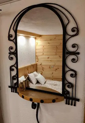 a bedroom with a mirror on a wall at Grancharova Guest House in Bansko