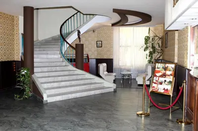 a lobby with a staircase in a building at Hotel Trakia in Pazardzhik