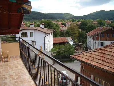 a view of a town from the balcony of a house at Yana Guest House in Dobrinishte