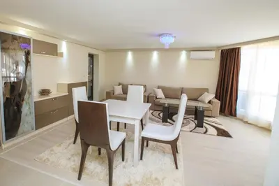 a dining room and living room with a table and chairs at Sundance Apartments in Sandanski