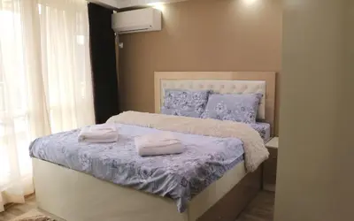 a bedroom with a bed with two towels on it at Sundance Apartments in Sandanski
