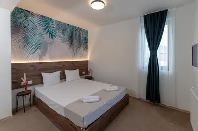 a bedroom with a bed and a painting on the wall at Вила Флора Паталеница in Patalenitsa