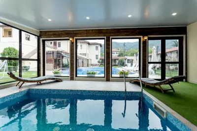 a swimming pool with a view of a house at Вила Флора Паталеница in Patalenitsa