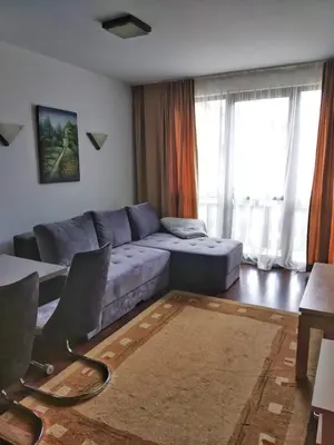 a living room with a couch and a table at Oksana's Apartment at Infinity in Bansko