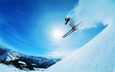 a person on skis jumping down a snow covered slope at Oksana's Apartment at Infinity in Bansko