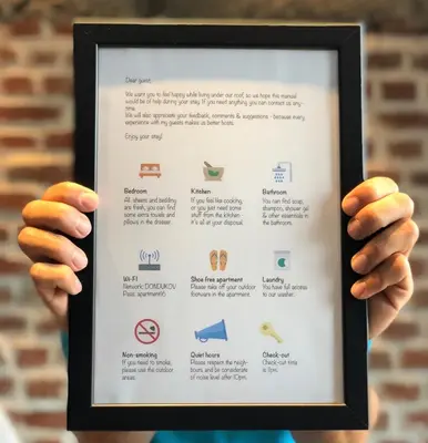 a person holding a framed picture of a menu at Golden Dome view Apartment in Sofia