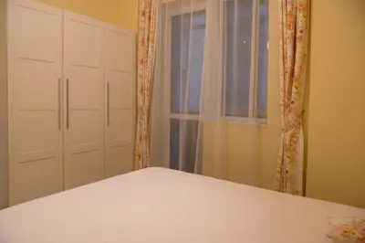 a bedroom with a bed and a window and a windowvisor at The North Tower Apartment in Sofia
