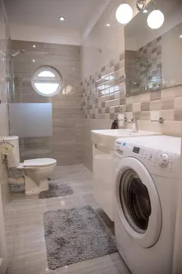 a bathroom with a washing machine and a toilet at The North Tower Apartment in Sofia