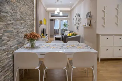 a kitchen and dining room with a table and chairs at The North Tower Apartment in Sofia