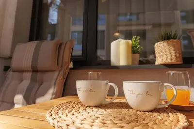 two coffee mugs sitting on top of a table at City Center Apartments with Parking in Plovdiv