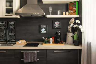 a kitchen with black walls and a stove top oven at City Center Apartments with Parking in Plovdiv
