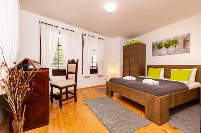 a bedroom with a bed and a desk and a chair at The House With The Piano in Plovdiv