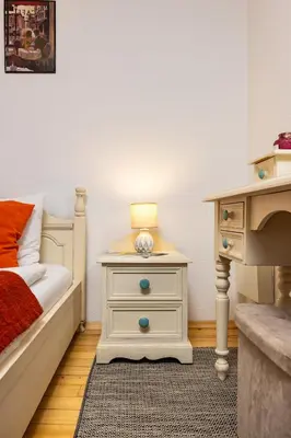 a bedroom with a bed and a table with a lamp at The House With The Piano in Plovdiv