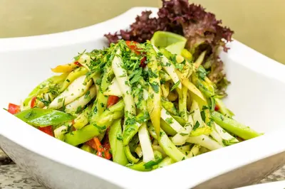 a white bowl of food with vegetables in it at Grami Hotel Sofia in Sofia