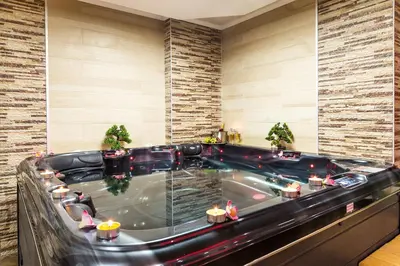 a jacuzzi tub in a hotel room at Grami Hotel Sofia in Sofia