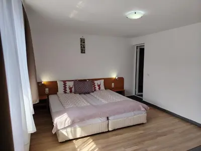 a bedroom with a large bed in a room at Guest House Lila in Bansko
