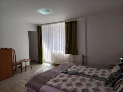 a bedroom with a bed and a large window at Guest House Lila in Bansko