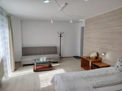 a living room with a couch and a table at Guest House Lila in Bansko