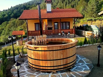 a house with a large wooden barrelickedigunigunigunigunigunigunigunigun at Villa Rupcovoto in Smolyan