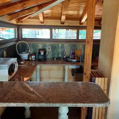 a kitchen with a counter top in a room at Къща за гости 