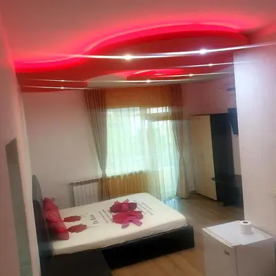 a room with a bed with a red ceiling at Къща за гости 