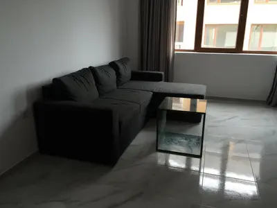 a living room with a couch and a glass table at Apartment Spa Holidays in Sandanski