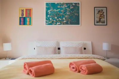 a bed with two pink towels on top of it at Veli Hills Apartments in Velingrad