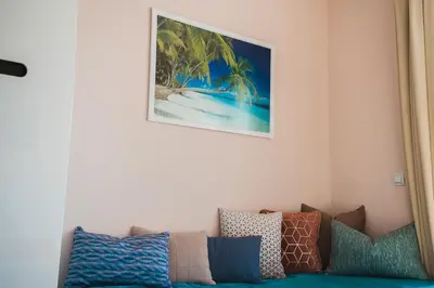 a living room with a couch and a picture on the wall at Veli Hills Apartments in Velingrad