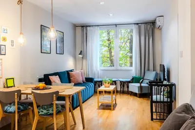 a living room with a couch and a table at Casa Dolce Far Niente, 2BATH&2BED, PARKING, Vitosha blvd in Sofia