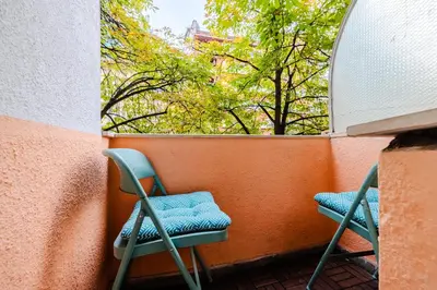 two chairs sitting on a balcony with a window at Casa Dolce Far Niente, 2BATH&2BED, PARKING, Vitosha blvd in Sofia