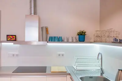 a white kitchen with a sink and a tub at Casa Dolce Far Niente, 2BATH&2BED, PARKING, Vitosha blvd in Sofia