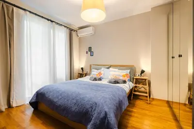 two cats sitting on a bed in a bedroom at Casa Dolce Far Niente, 2BATH&2BED, PARKING, Vitosha blvd in Sofia