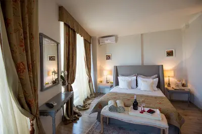 a bedroom with a bed and a table with shoes on it at Hotel Tempo Boutique in Pazardzhik