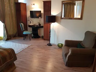 a living room with a couch and a desk at Hotel Tempo Boutique in Pazardzhik
